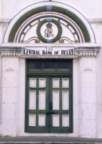 The front door of the central bank with a crest in the archway above and columns either side.