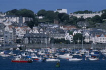 St Peter Port. View from across sea towards marina and quayside buildings.