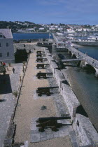 St Peter Port. Castle Cornet. View above Cannons lined up next to castle wall.