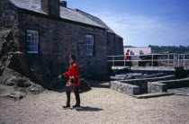St Peter Port. Castle Cornet. Noon Day Guard walking in grounds.