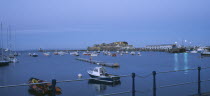 St Peter Port. Cornet Castle at dusk seen from across water.