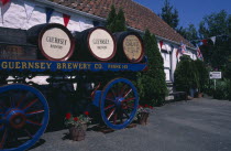 Forest Parish. German Occupation Museum. Brewery barrels on cart displayed outside main entrance.