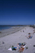 Castel. Cobo Bay. Sandy beach with sunbathers Resort Seaside Shore Tourism