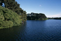 St Saviours Reservoir with fishermen wading in water
