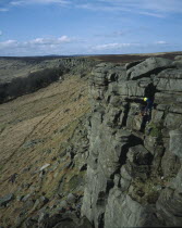 View northwards along edgeof gritstone craggs with rock climbers.