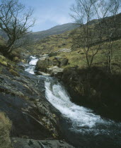 Waterfall cascading over rocks in stream flowing south east from Snowdon to Nant Gwynant