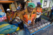 Miniature steel drum pan player and band playing at a roadside bar during Easterval Easter Carnival in Clifton