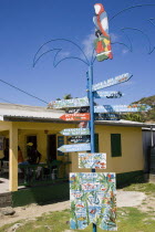 Signpost beside a rum shop in Clifton