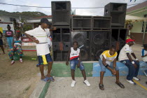 Young men sitting beneath a sound system at the Easterval Easter Carnival in Clifton