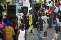 Policeman leading away a young man for a word beyond the sound system at Easterval Easter Carnival in Clifton