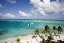 Tourists and moored yachts off the beach at Jamesby Island