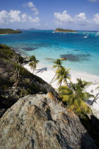 View over the beach of Jamesby Island and moored yachts towards Canouan on the horizon