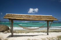 Hammock under a shelter by the beach at Palm Island Resort