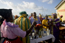 Women handing out donated goods amongst the Baptist congregation in Clifton at Easter morning harbourside service for those lost at sea