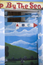 Wall painting in Clifton depicting a woman at a well in a green valley