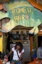 Woman serving coffee at roadside bar in Clifton