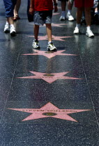 Hollywood. Pink marble and bronze stars embedded into Hollywood Boulevard sidewalk aka Hollywood walk of Fame