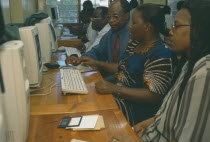 Adult students learning computer skills.