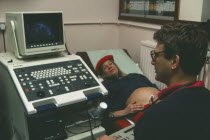 Woman having ultra sound scan at twenty seven weeks.