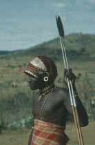 Threequarter portrait of Masai Moran warrior holding spear