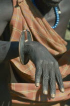 Cropped shot of Karamojong Dodoth warrior displaying wrist knife used for cutting meat and as a weapon before the use of guns  Pastoral tribe of the Plains Nilotes group related to the Masi