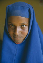 Portrait of Somali girl in blue head dress.  The Somali are one of the key ethnic groups in Ethiopia and are largely Muslim pastoralists. Moslem