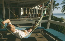 Man relaxing in hammock at the Rum Point Inn