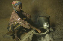 Woman cooking on a locally made energy saving stove