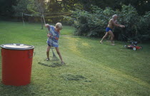 Father and eight year old boy gardening.