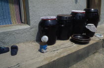 Ceramic jars of kimchi traditional pickled vegetables standing on doorstep of house in east coast fishing port.