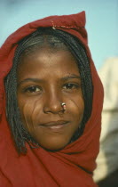 Portrait of a young Eritrean woman with scarified cheeks and a nose ring