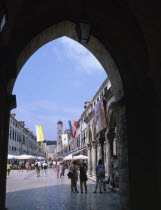 View along flag lined street from archway of Ploce Gate