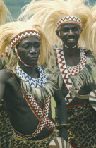 Tutsi dancers wearing lion mane head dresses.