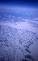 Aerial view of snow covered tundra from plane