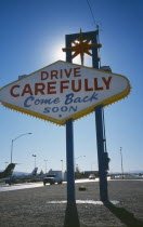 USA, Nevada, Las Vegas, Drive Carefully Come Back Soon sign on the Strip next to McCarran Airport