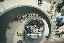 The Louvre interior. View looking down spiral staircase to central hydraulic lift