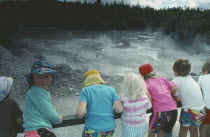 Mud Pool with kids leaning against fence.