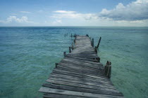 Derelict wooden jetty leading out to sea