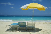 Umbrella and sun loungers on beach
