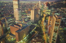 Aerial view of city highrises illuminated at night