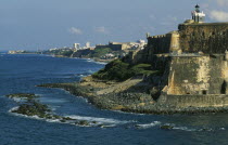 View along San Juan coastline with fort and old city walls.