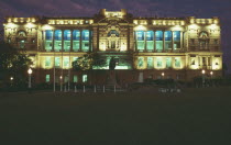 State buildings floodlit at night.