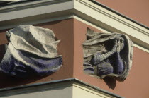 Building detail showing a flying nun passing through the corner of a building