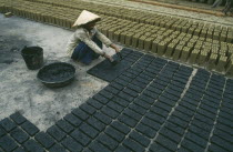 Brick production worker laying out newly made bricks