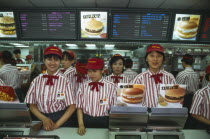 McDonalds staff standing behind the counter.