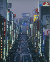 View down the Ginza at night busy with people and traffic