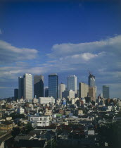 View over city rooftops with high-rise buildings and skyscrapers in the background