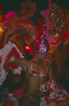 Tropicana Club female dancer in pink costume in front of other dancers