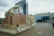 Children climb on large modern sculpture at a Birmingham Convention Centre