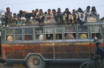 Local bus crowded with people inside and on the roof